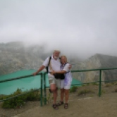 Lois and Gunter in front of green teal crater lake