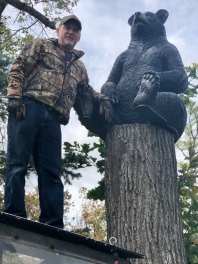 Standing atop his ATV, Mike mounts the bear statue.